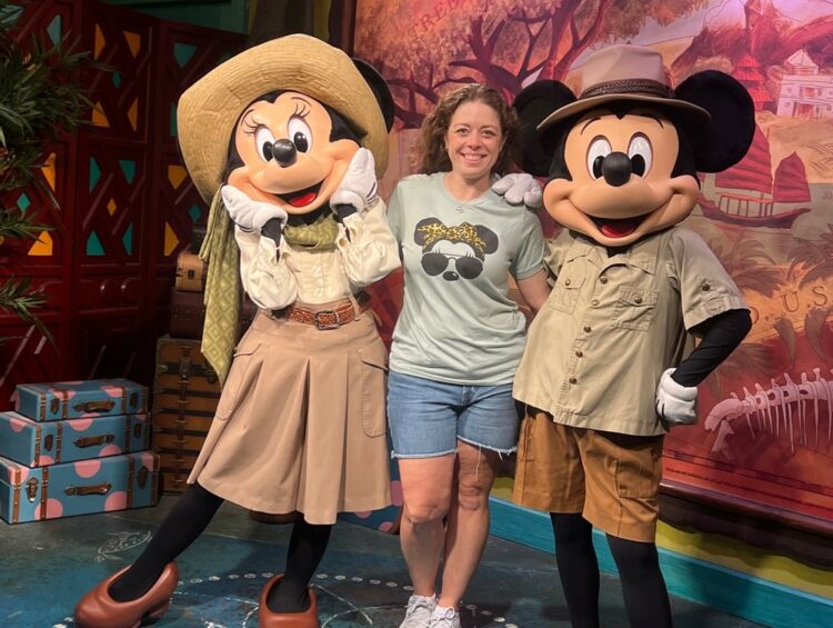 Female with Mickey and Minnie who are dressed in their safari attire.