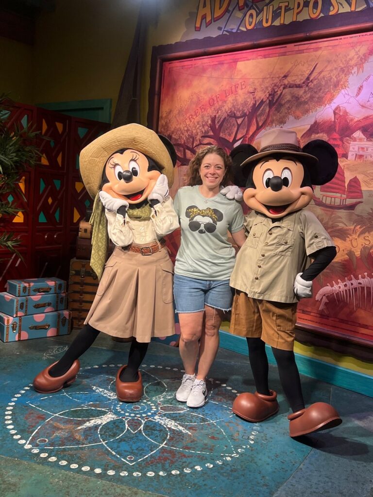 Female with Mickey and Minnie who are dressed in their safari attire.